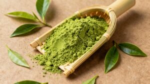 Premium Japanese matcha powder in a bamboo scoop.