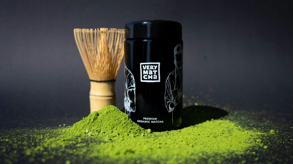 Matcha powder and whisk with a black container